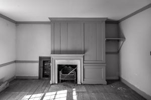 Second-story chamber with now-blocked door to kneewall of wing; 